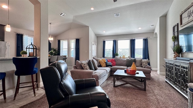 living room with plenty of natural light, carpet floors, and lofted ceiling