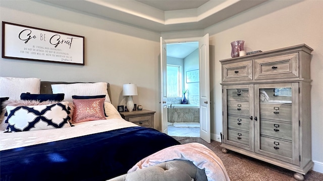 carpeted bedroom featuring ensuite bath