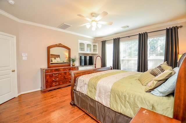 bedroom with ceiling fan, light wood-type flooring, and ornamental molding