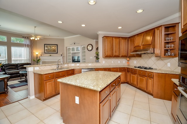 kitchen with premium range hood, sink, a kitchen island, light stone counters, and kitchen peninsula