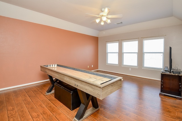 recreation room with ceiling fan, hardwood / wood-style floors, and lofted ceiling