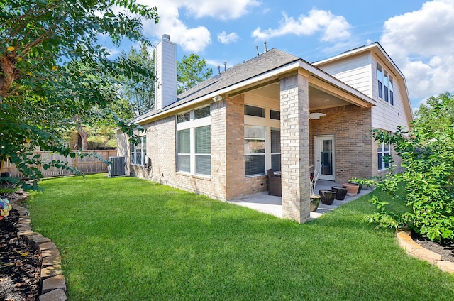 back of property featuring a patio, central AC, and a lawn