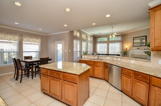 kitchen with light stone countertops, dishwasher, a healthy amount of sunlight, and sink