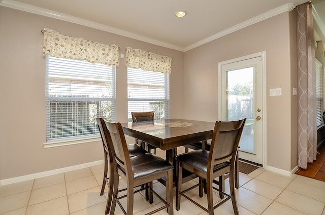 tiled dining space featuring crown molding