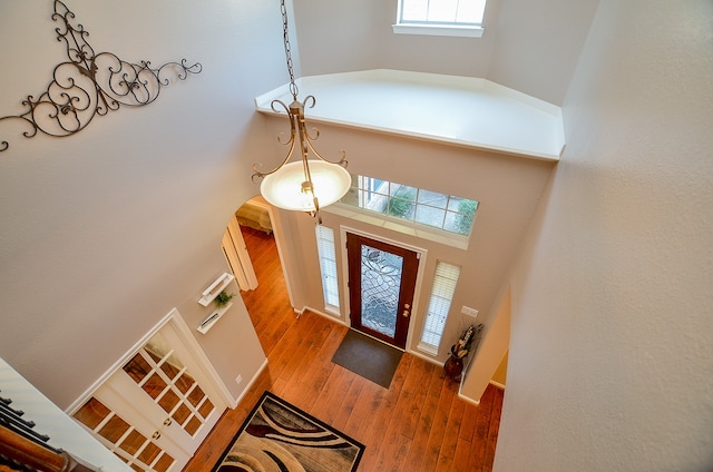 foyer entrance featuring a high ceiling and hardwood / wood-style flooring