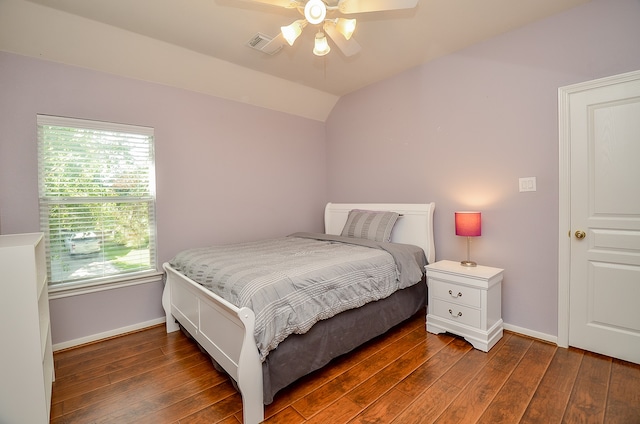 bedroom featuring ceiling fan, dark hardwood / wood-style flooring, and lofted ceiling