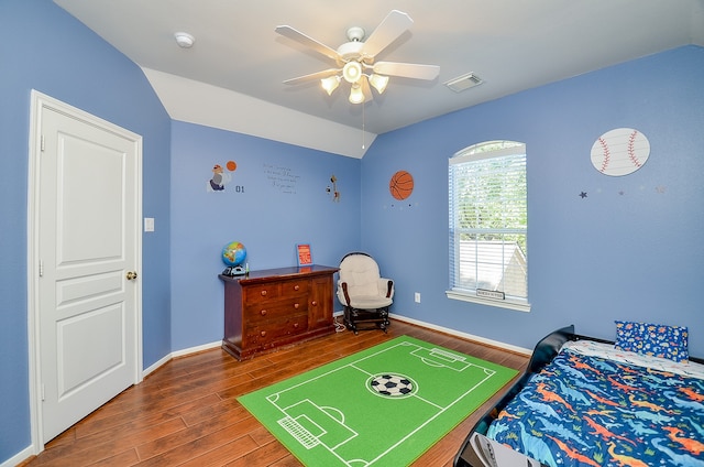 bedroom featuring ceiling fan, hardwood / wood-style floors, and lofted ceiling