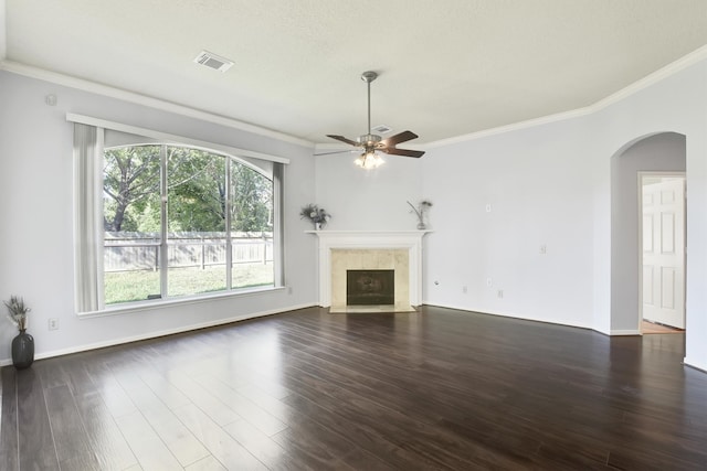 unfurnished living room featuring ceiling fan, dark hardwood / wood-style floors, and ornamental molding