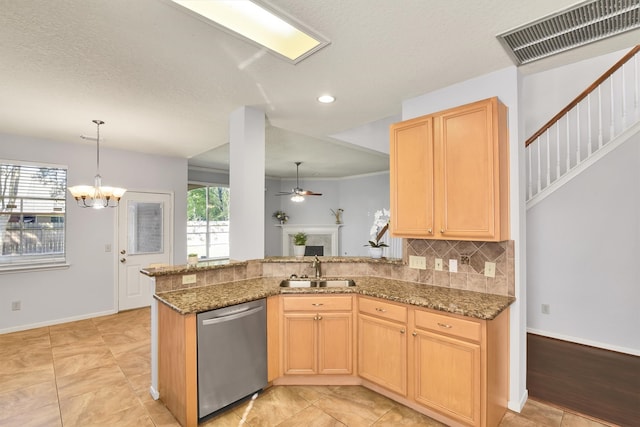 kitchen with dishwasher, sink, dark stone countertops, light brown cabinetry, and kitchen peninsula