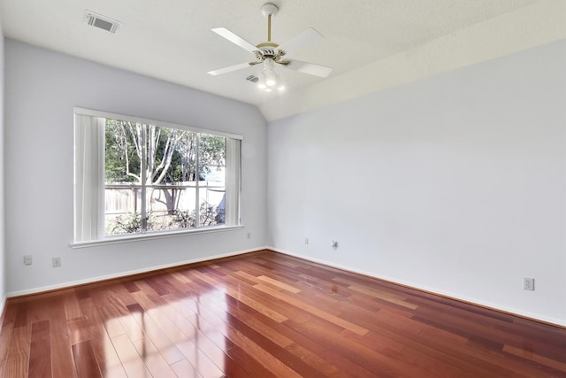 spare room featuring hardwood / wood-style floors, ceiling fan, a textured ceiling, and vaulted ceiling