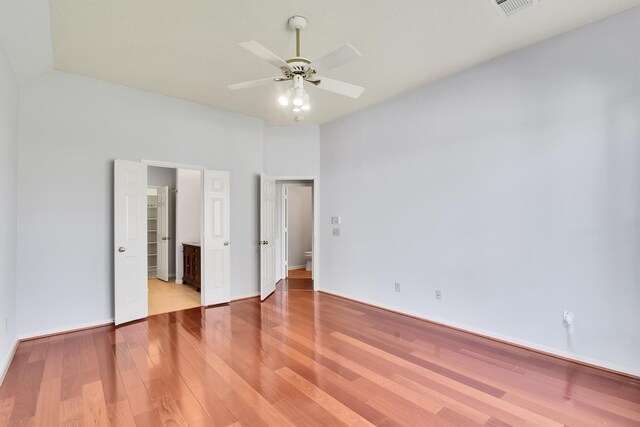 unfurnished bedroom with wood-type flooring and ceiling fan