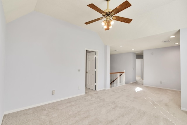 unfurnished room featuring ceiling fan, lofted ceiling, and light carpet