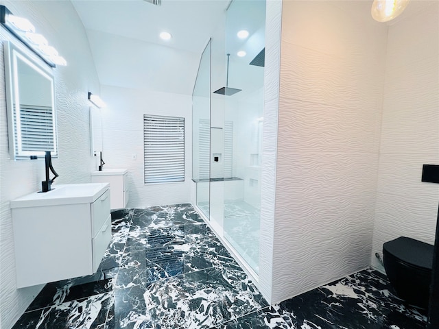 bathroom with vanity, toilet, and a tile shower