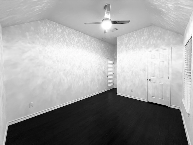 unfurnished room featuring ceiling fan, dark wood-type flooring, and vaulted ceiling