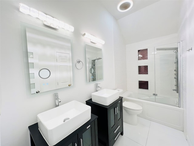 full bathroom with tile patterned flooring, vanity, combined bath / shower with glass door, and toilet