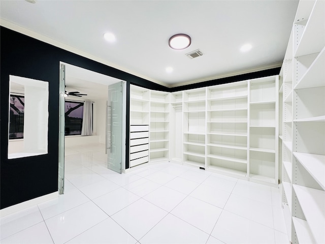 walk in closet with ceiling fan and light tile patterned floors