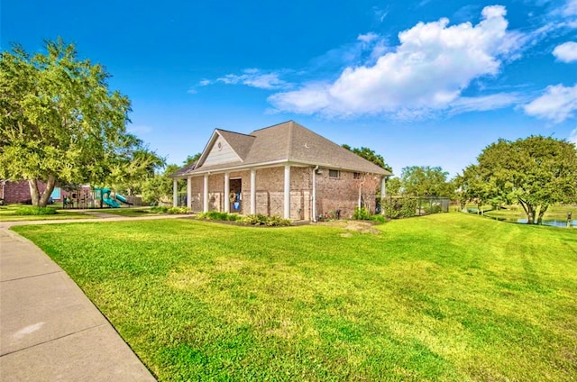 view of side of home with a playground and a lawn