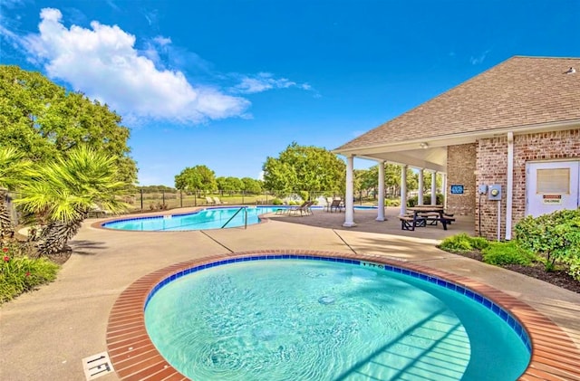 view of swimming pool with a patio