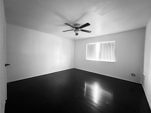 unfurnished room with ceiling fan and wood-type flooring