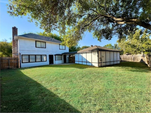 back of property featuring a lawn