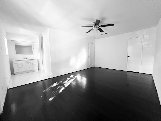 empty room with ceiling fan and wood-type flooring