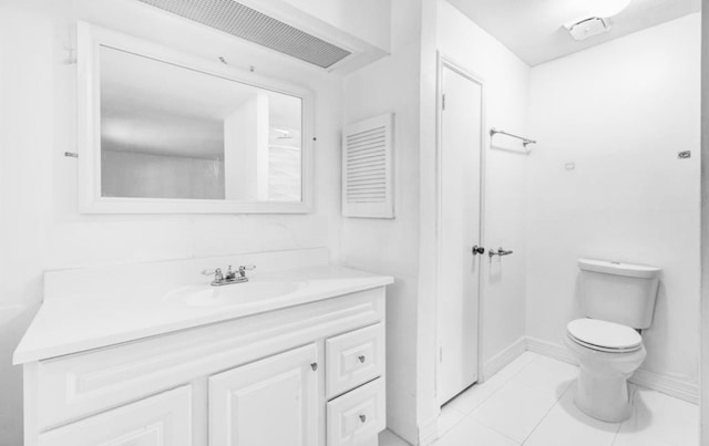 bathroom featuring tile patterned floors, vanity, and toilet