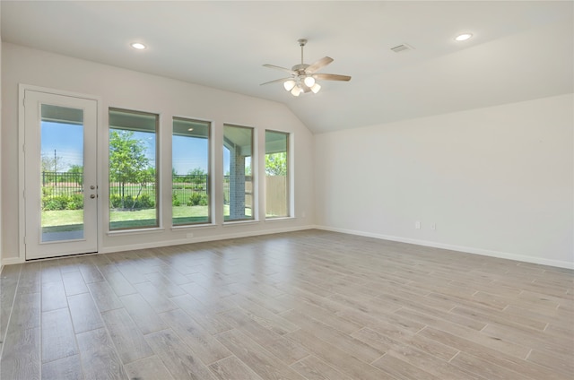 unfurnished room with ceiling fan, light hardwood / wood-style floors, and vaulted ceiling