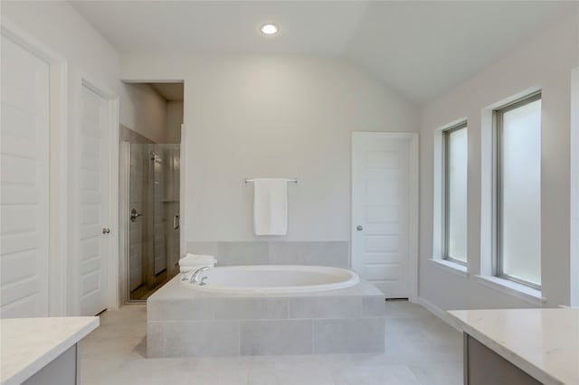 bathroom with tile patterned flooring, vanity, lofted ceiling, and independent shower and bath