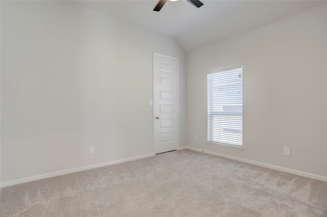 carpeted spare room with ceiling fan and lofted ceiling