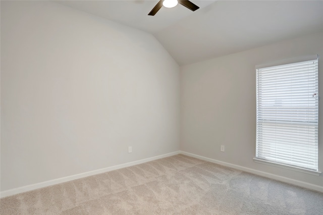 carpeted empty room with ceiling fan and lofted ceiling