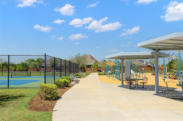 view of property's community with a playground and tennis court