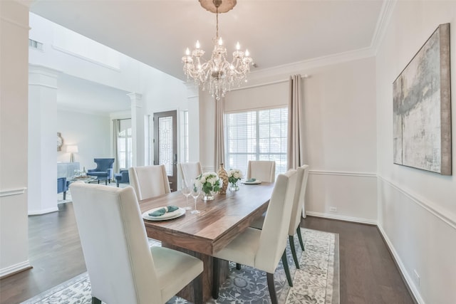 dining area with dark hardwood / wood-style flooring, crown molding, decorative columns, and a healthy amount of sunlight