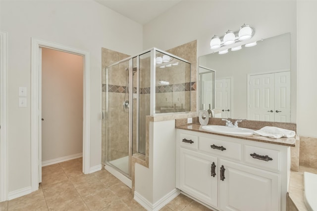 bathroom featuring vanity, tile patterned floors, and a shower with door