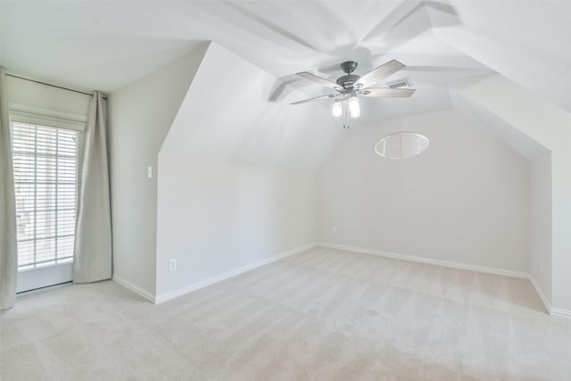 additional living space featuring light carpet, vaulted ceiling, and ceiling fan