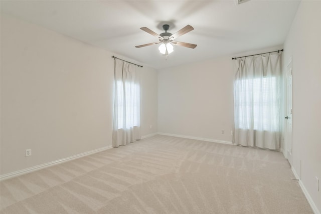 carpeted spare room with ceiling fan