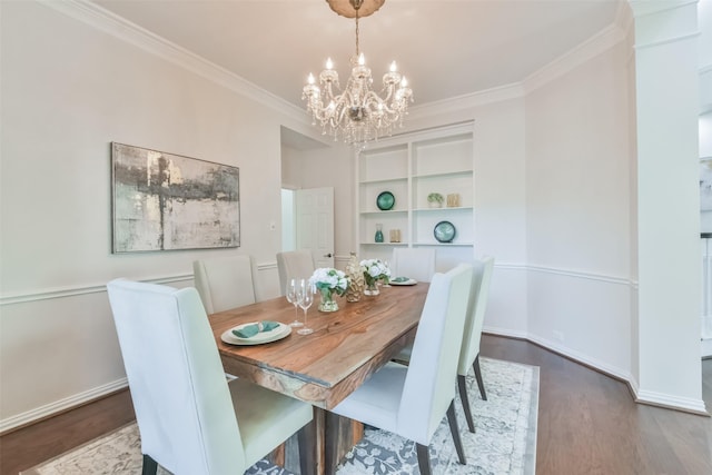 dining room featuring hardwood / wood-style flooring, ornamental molding, and a notable chandelier