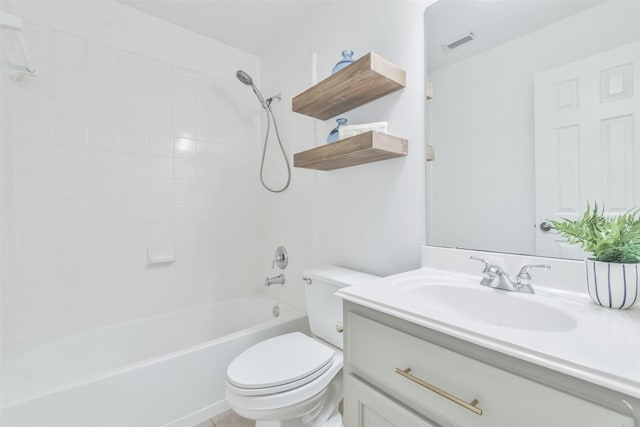 full bathroom featuring vanity, tiled shower / bath, and toilet