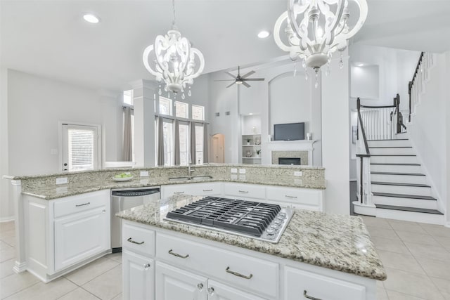 kitchen featuring a kitchen island, appliances with stainless steel finishes, pendant lighting, and white cabinets