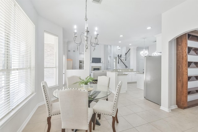 tiled dining space featuring an inviting chandelier