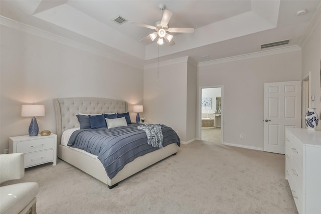 bedroom featuring ornamental molding, light colored carpet, and a tray ceiling