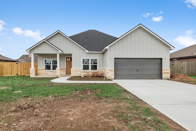 modern farmhouse featuring covered porch and a garage