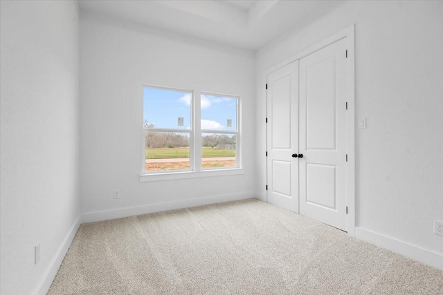 carpeted empty room with baseboards