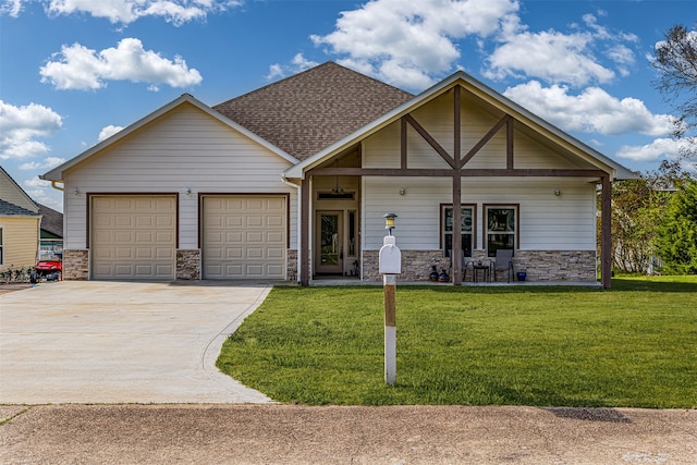 view of front of home with a front lawn, covered porch, and a garage