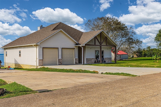 view of front of home with a front lawn and a garage