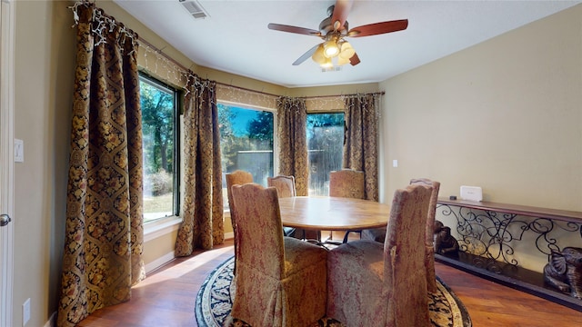 dining area with ceiling fan and hardwood / wood-style floors