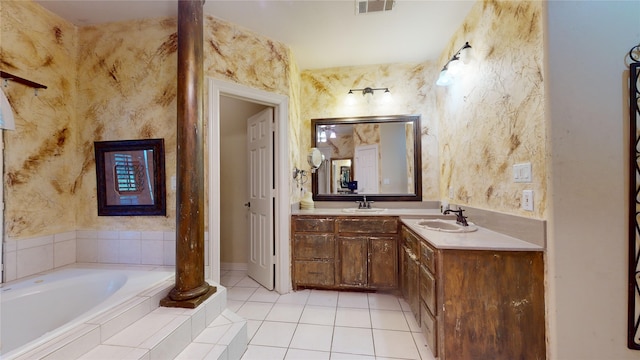 bathroom featuring tile patterned floors, vanity, and tiled bath