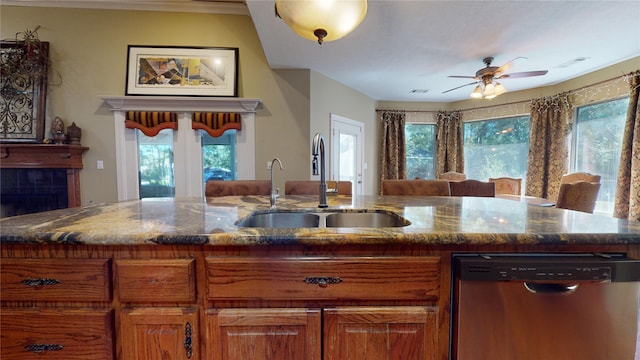 kitchen with stainless steel dishwasher, plenty of natural light, ceiling fan, and sink