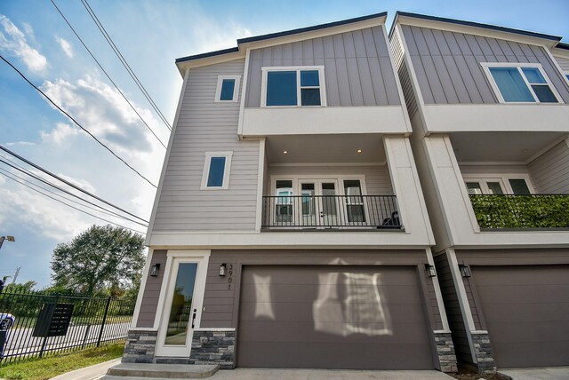 multi unit property featuring a garage and a balcony