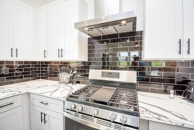 kitchen with white cabinetry, stainless steel gas stove, decorative backsplash, and range hood