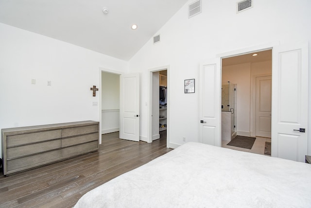 bedroom featuring dark hardwood / wood-style flooring, a spacious closet, high vaulted ceiling, and a closet